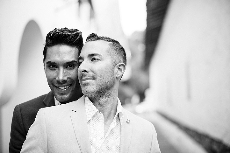 black and white couple hugging in white corridor