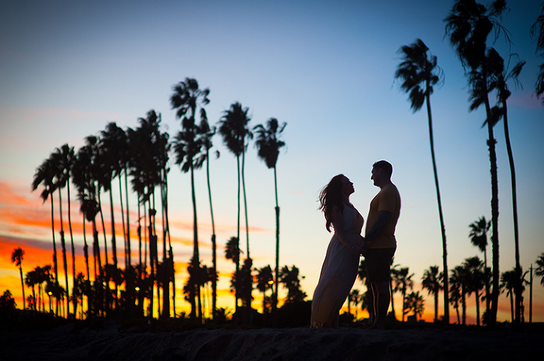 silhouette of couple in front of outline of palm trees in Santa Barbara