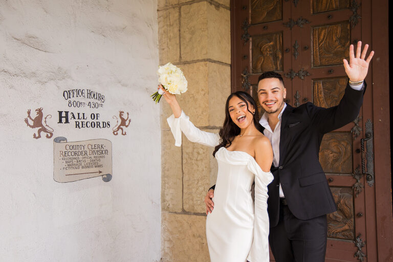 Bride and groom cheering outside Santa Barbara Courthouse Hall of Records