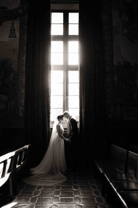 Bride and Groom forehead to forehead in the Mural Room of Santa Barbara Courthouse