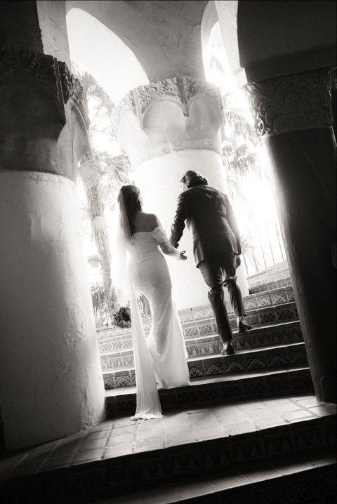 Bride and groom walking up the circular staircase of Santa Barbara Courthouse