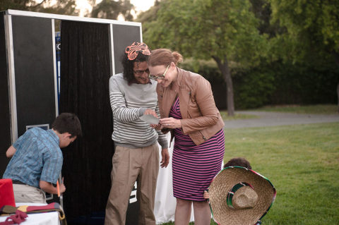 guests looking at photo booth photos