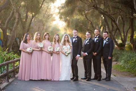 wedding party standing in tree pathway