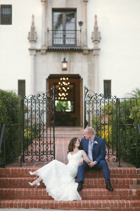 bride and groom sitting on brick steps