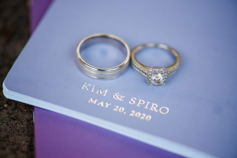 Wedding rings on vows with wedding date embossed on them