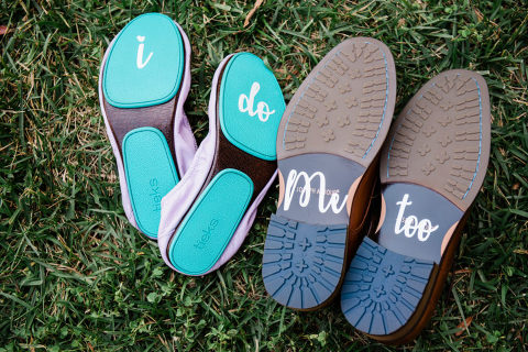 I Do written on brides shoe wear. Me, too written on bottom of groom's shoes.