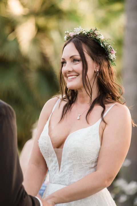 bride wearing a floral crown smiling at her Santa Barbara Zoo wedding