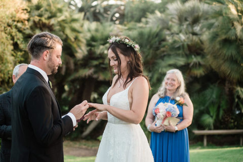 bride and groom exchanging rings at their Santa Barbara Zoo wedding