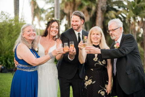 bride and groom and their parents celebrating with champagne at their Santa Barbara Zoo wedding