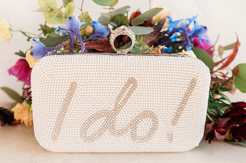 White beaded bridal clutch purse with words I Do! written on front.