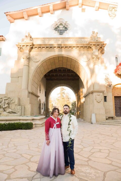 bride in hanbok and groom is tagalog barong in front of santa Barbara courthouse