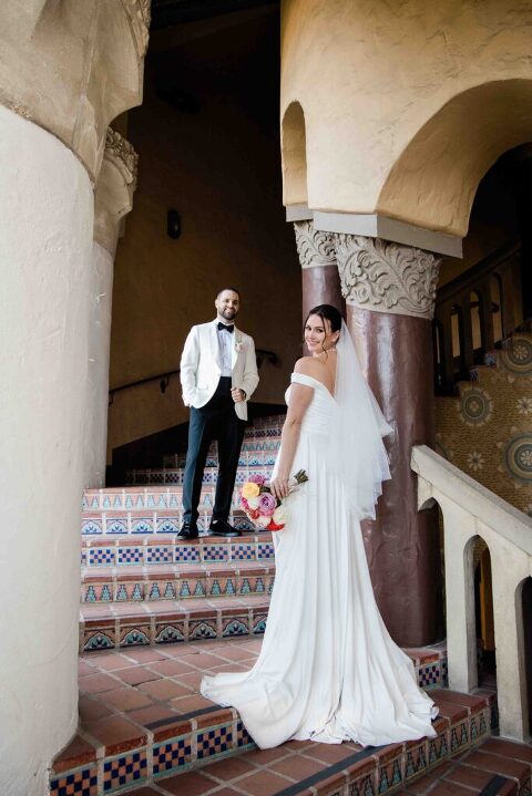 Bride and Groom posing the staircase of Santa Barbara Courthouse