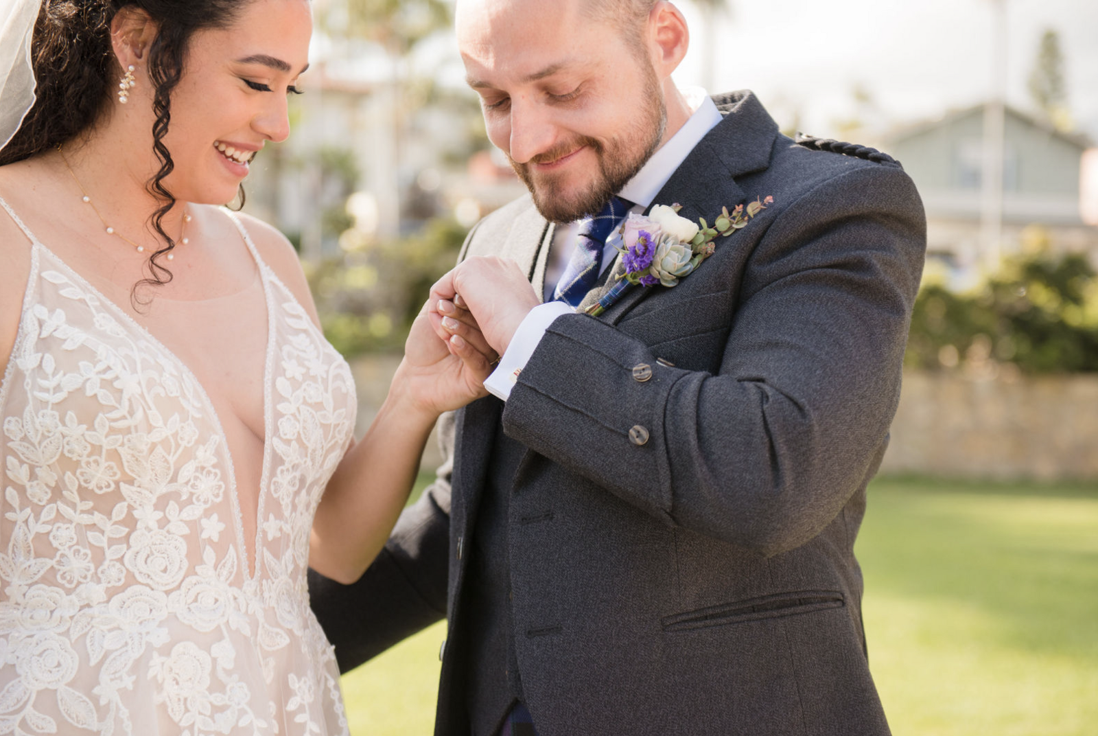 groom looking at his new wedding band on his finger